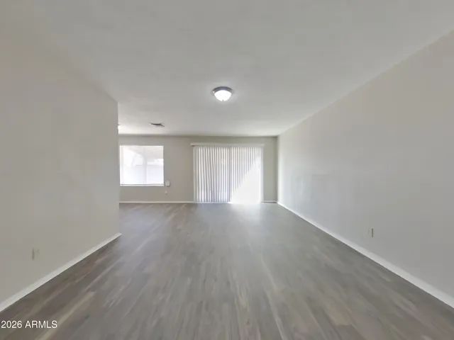 a view of a room with wooden floor and window