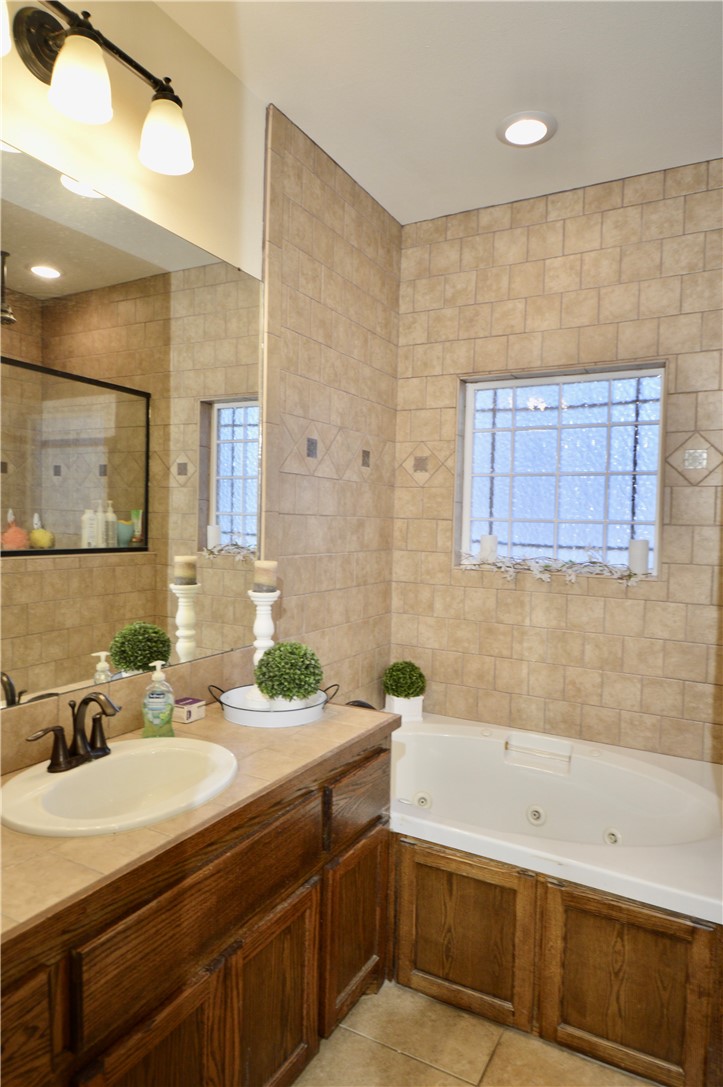 1717 Agarito Avenue Alice, TX 78332 - Photo 12 of 25 a bathroom with a bathtub and a sink