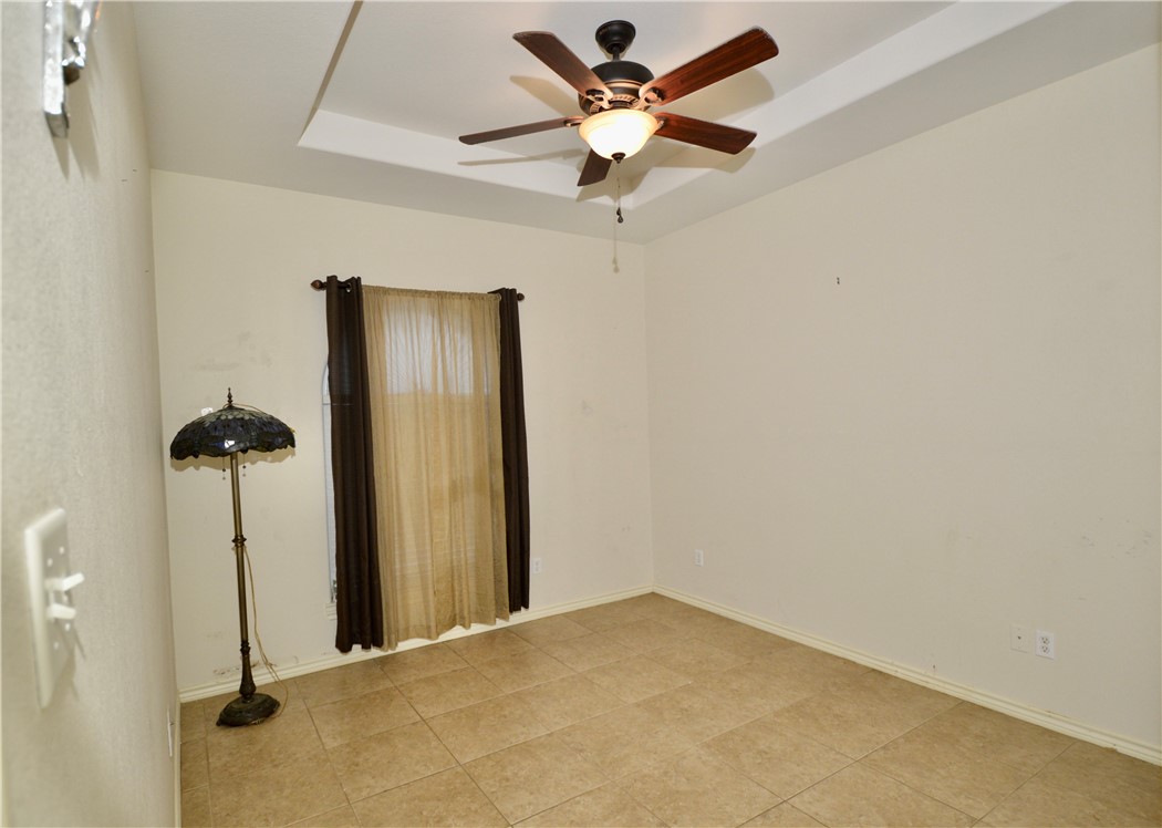 1717 Agarito Avenue Alice, TX 78332 - Photo 17 of 25 a view of a hallway with a chandelier fan