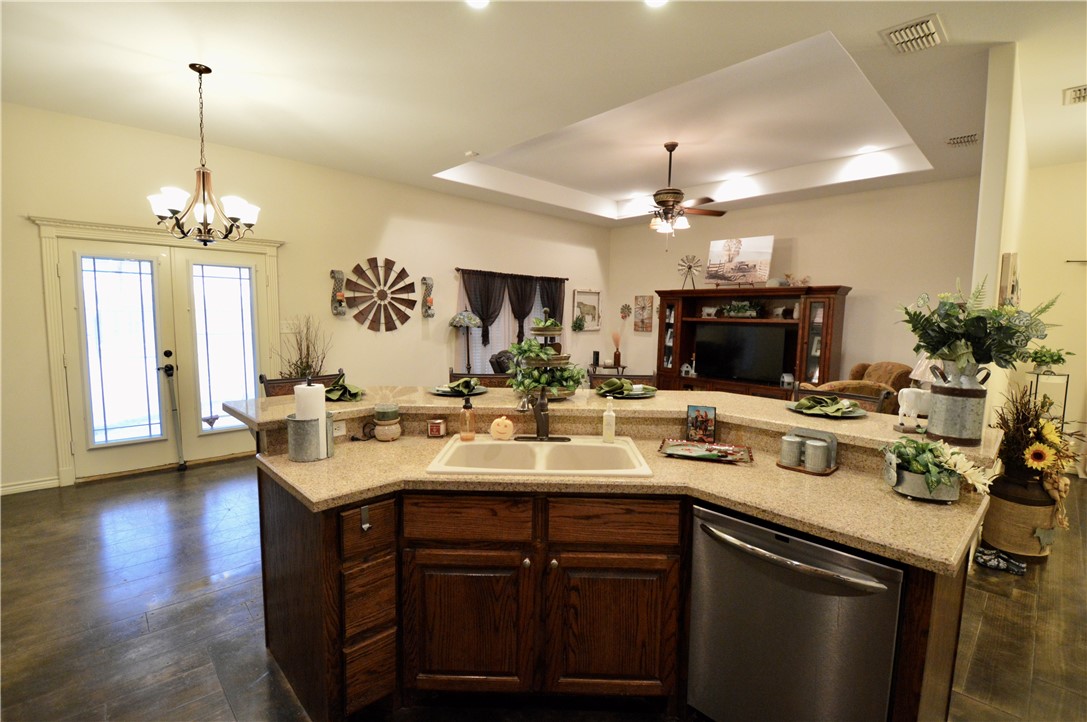 1717 Agarito Avenue Alice, TX 78332 - Photo 19 of 25 a kitchen with a sink and chandelier
