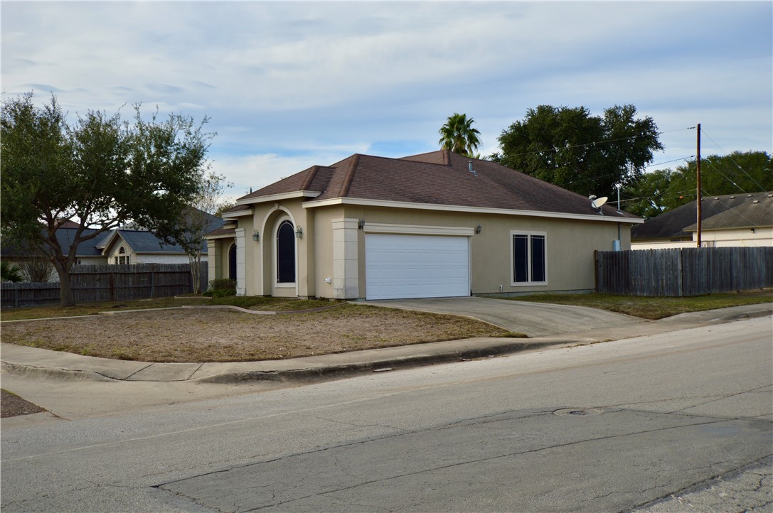 1717 Agarito Avenue Alice, TX 78332 - Photo 2 of 25 a white house with a yard and plants