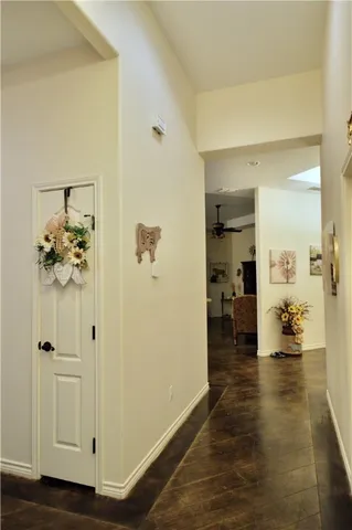 a view of a hallway with wooden floor windows and a livingroom