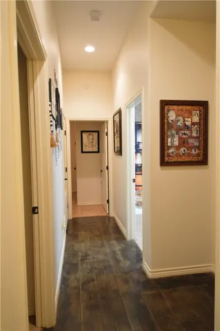 a view of a hallway with wooden shelves