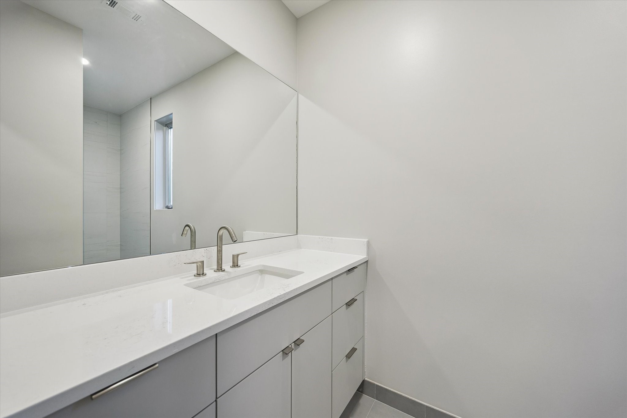 2129 Quenby Street Houston, TX 77005 - Photo 19 of 39 a bathroom with a sink and a mirror