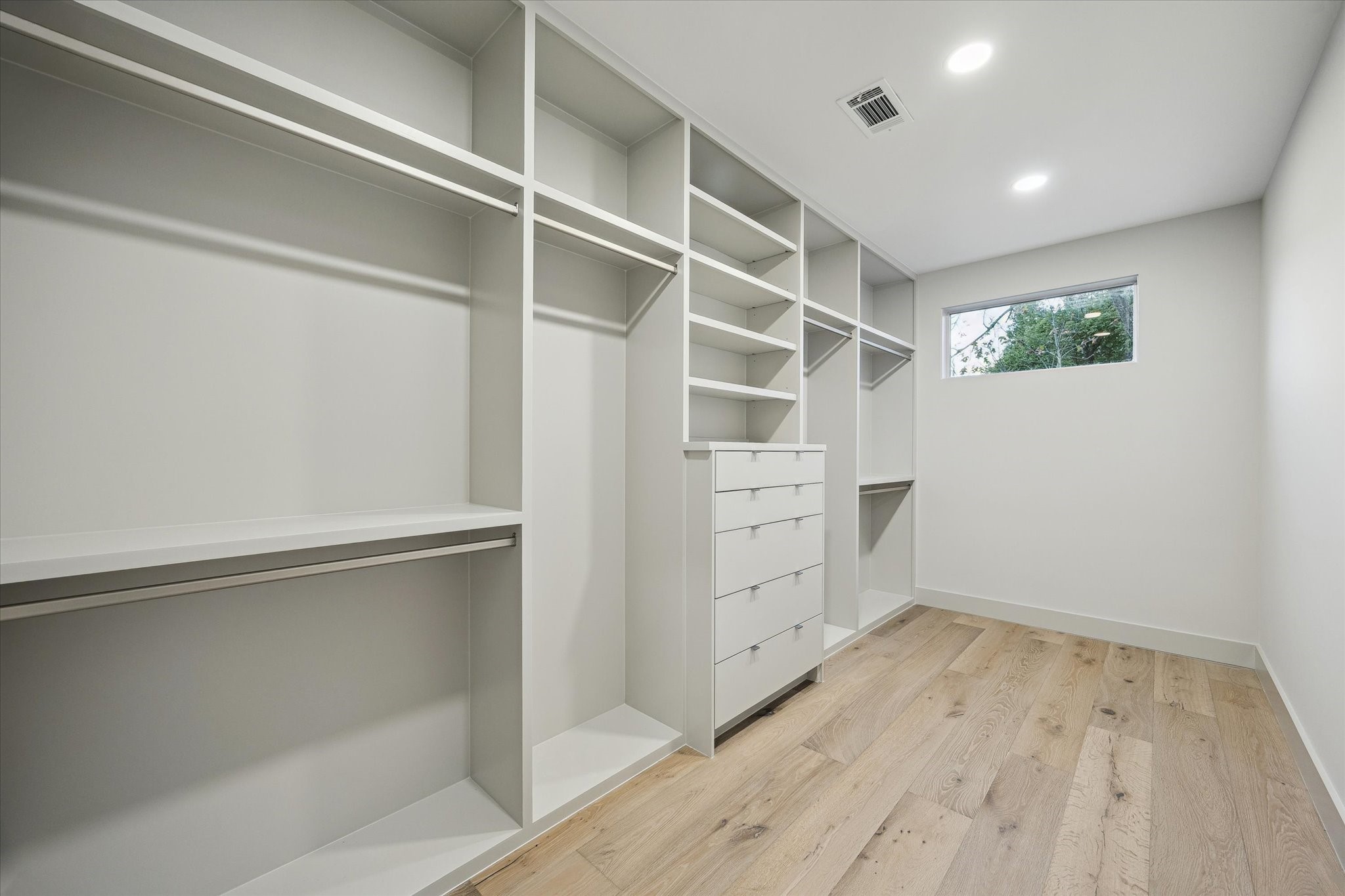 2129 Quenby Street Houston, TX 77005 - Photo 31 of 39 a view of walk in closet with empty racks