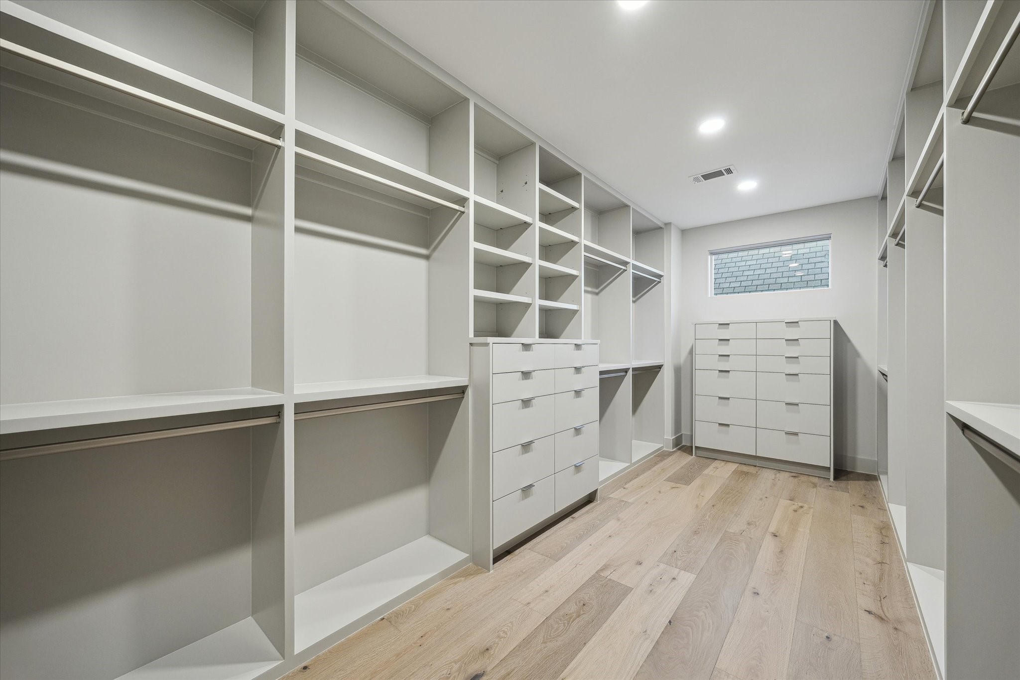 2129 Quenby Street Houston, TX 77005 - Photo 32 of 39 a view of walk in closet with empty racks