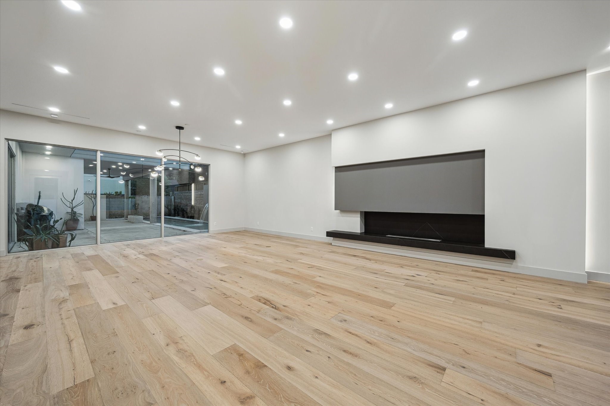 2129 Quenby Street Houston, TX 77005 - Photo 4 of 39 a view of empty room with wooden floor and fireplace