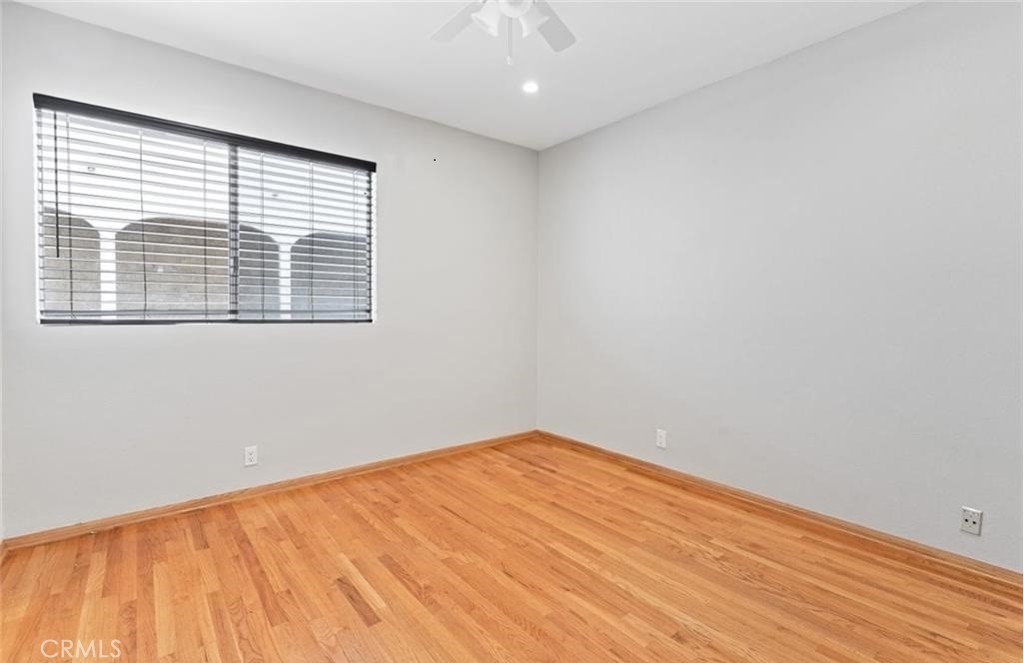 4705 Kester Avenue, Unit 209 Sherman Oaks, CA 91403 - Photo 16 of 18 an empty room with wooden floor and windows