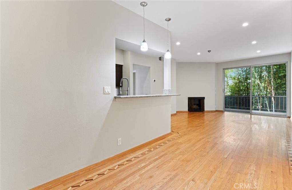 4705 Kester Avenue, Unit 209 Sherman Oaks, CA 91403 - Photo 6 of 18 a view of empty room with wooden floor and fan