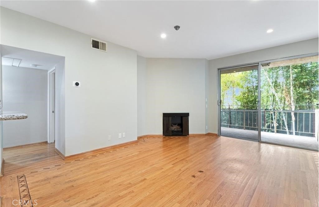 4705 Kester Avenue, Unit 209 Sherman Oaks, CA 91403 - Photo 9 of 18 a view of empty room with wooden floor and fan