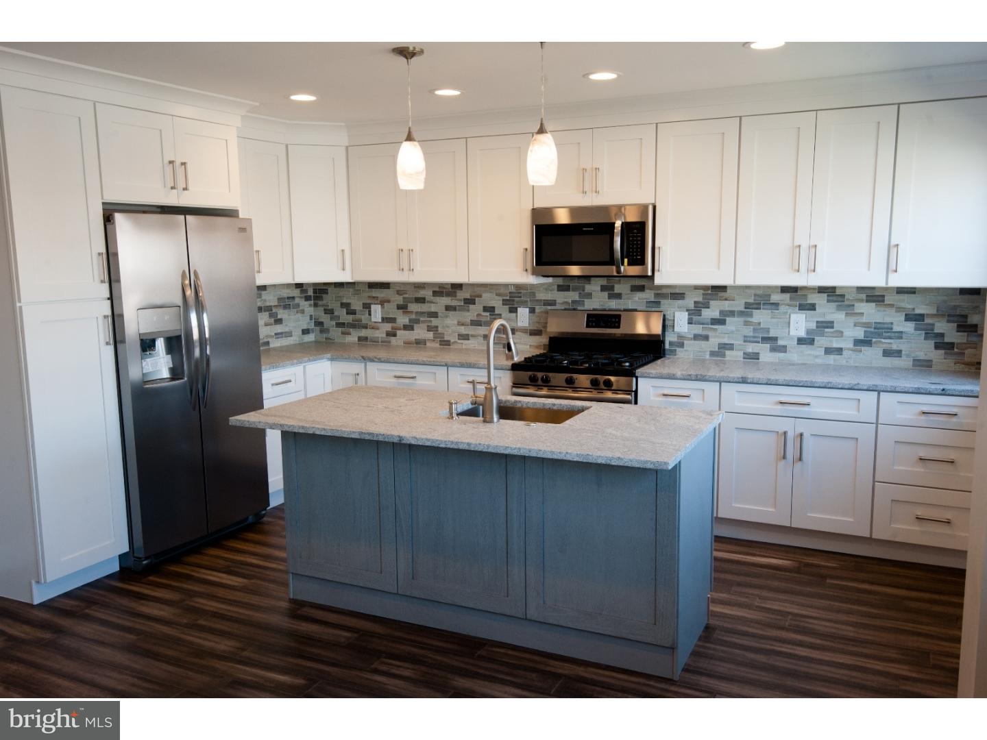 3302 Gurley Road Philadelphia, PA 19154 - Photo 2 of 25 a kitchen with a sink a microwave a refrigerator and cabinets