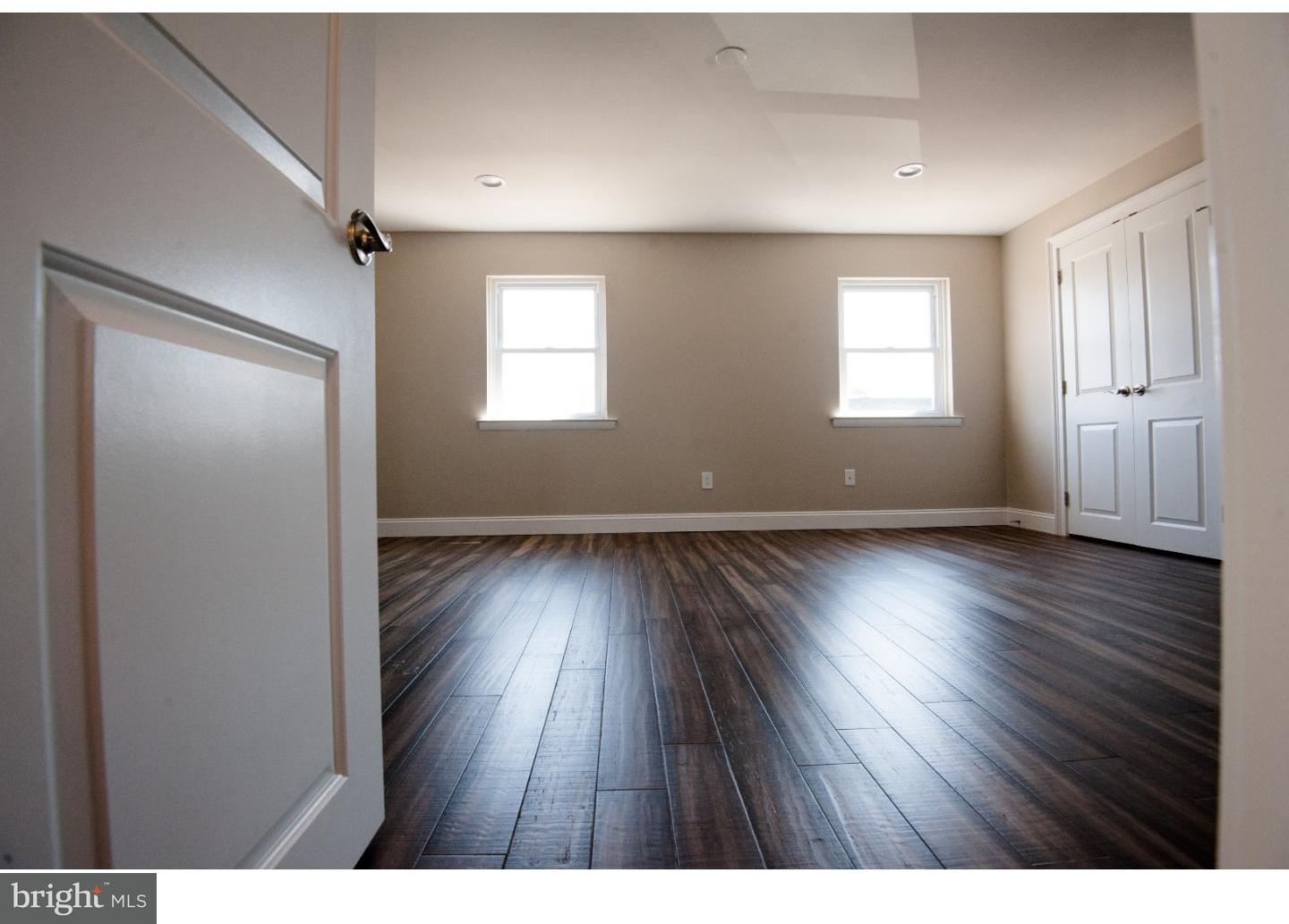 3302 Gurley Road Philadelphia, PA 19154 - Photo 17 of 25 a view of an empty room with wooden floor and a window