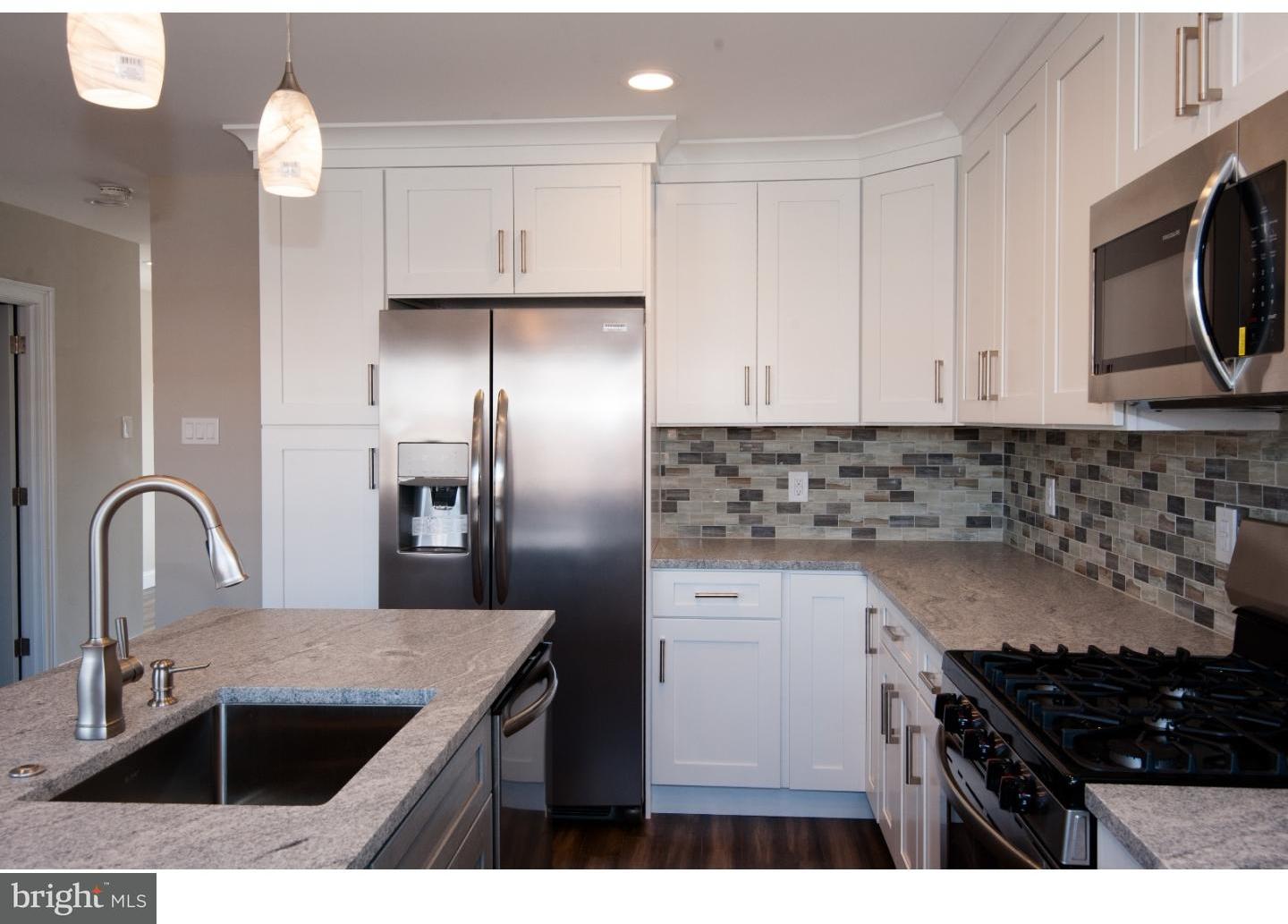 3302 Gurley Road Philadelphia, PA 19154 - Photo 3 of 25 a kitchen with kitchen island granite countertop a sink stainless steel appliances and cabinets