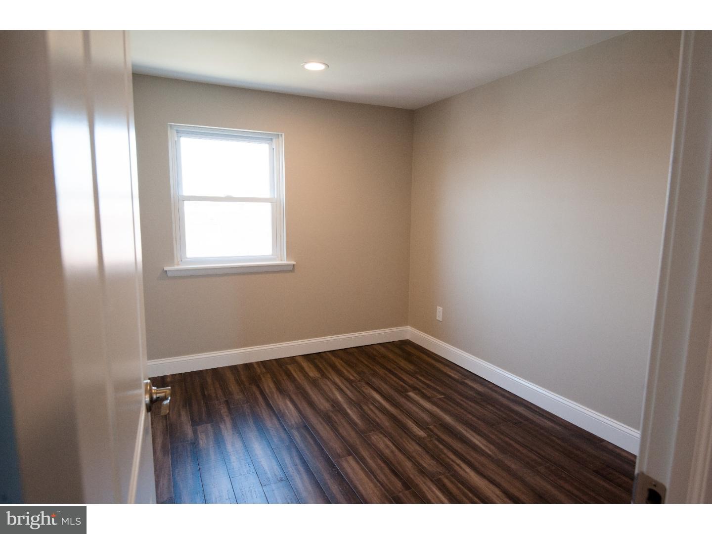 3302 Gurley Road Philadelphia, PA 19154 - Photo 21 of 25 a view of an empty room with wooden floor and a window