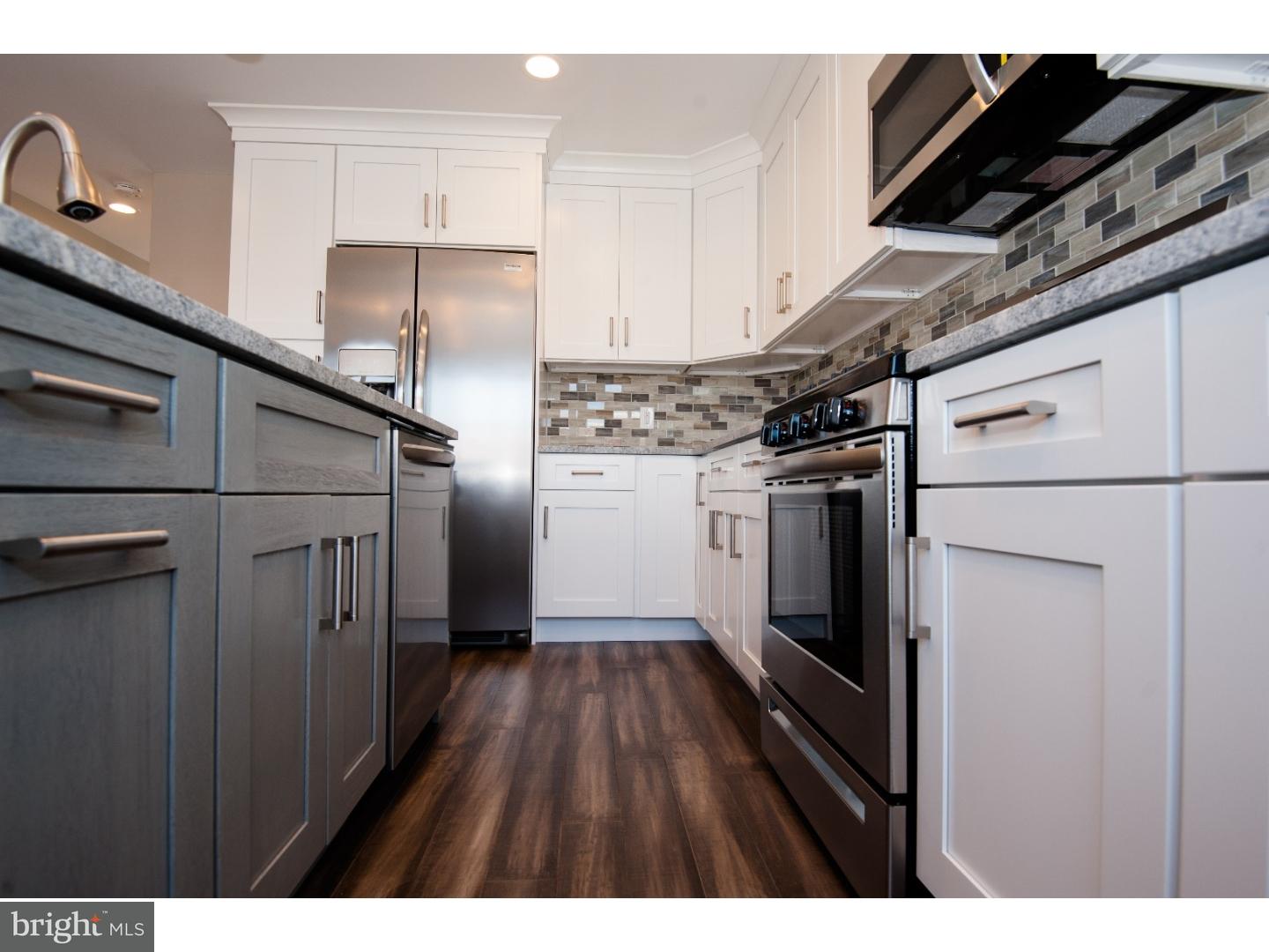 3302 Gurley Road Philadelphia, PA 19154 - Photo 4 of 25 a kitchen with stainless steel appliances a refrigerator and a wooden floor
