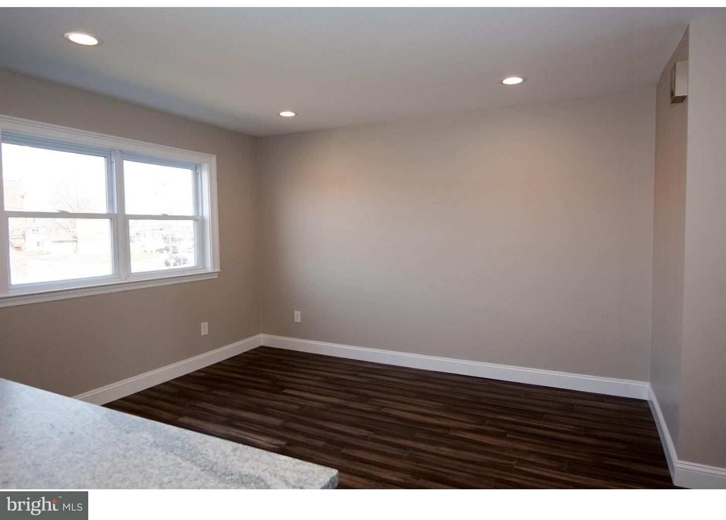 3302 Gurley Road Philadelphia, PA 19154 - Photo 5 of 25 a view of an empty room with wooden floor and a window