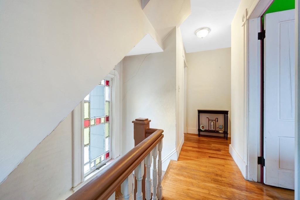62 Fargo Street Springfield, MA 01119 - Photo 24 of 38 a view of a hallway with wooden floor and staircase