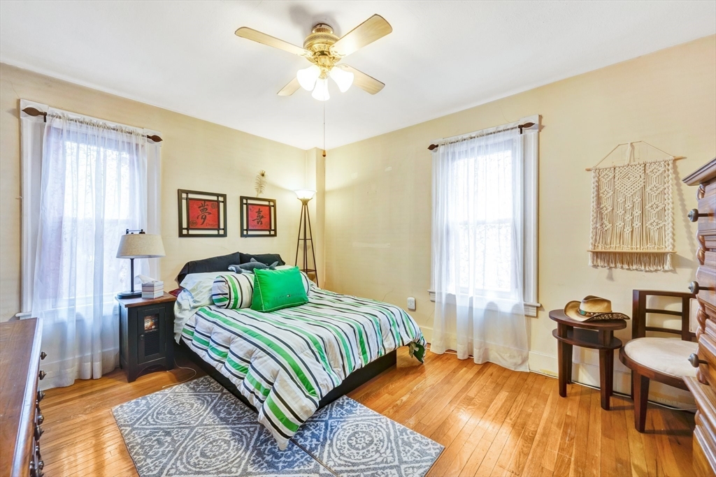 62 Fargo Street Springfield, MA 01119 - Photo 29 of 38 a bedroom with a bed and wooden floor