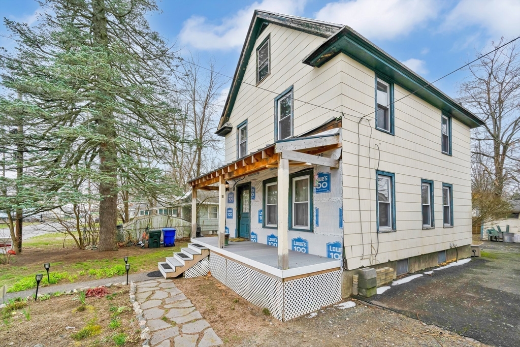 62 Fargo Street Springfield, MA 01119 - Photo 5 of 38 a view of a white house with a large windows and table and chairs in a patio