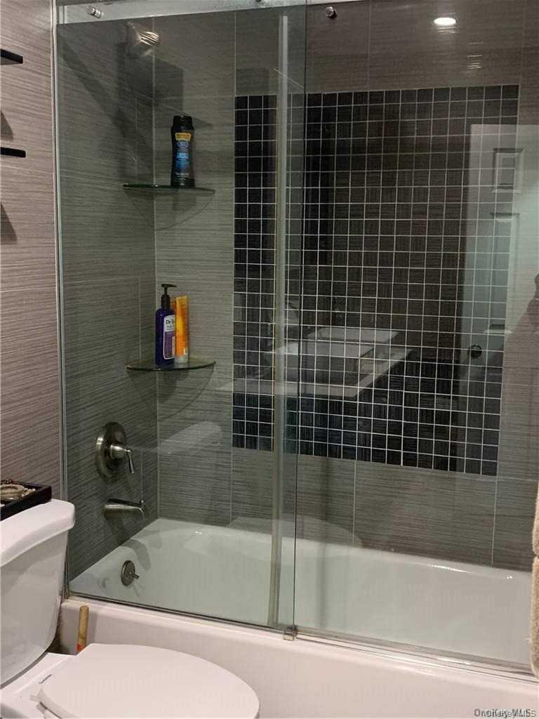 137-33 158th Street Queens, NY 11434 - Photo 11 of 21 a bathroom with a bathtub and a shower