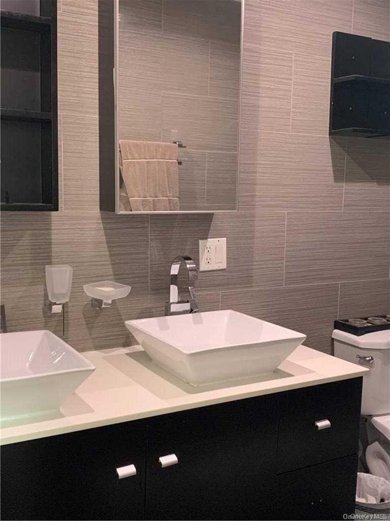 137-33 158th Street Queens, NY 11434 - Photo 9 of 21 a bathroom with a sink and a mirror