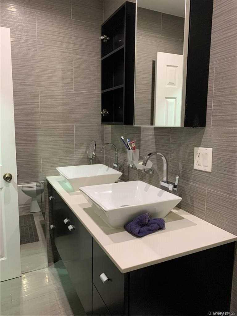 137-33 158th Street Queens, NY 11434 - Photo 10 of 21 a bathroom with a sink and a mirror