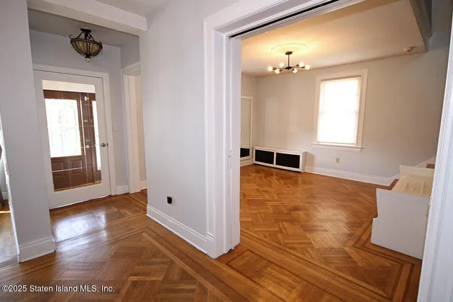 a view of a livingroom with wooden floor and a large window