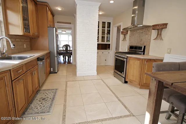 a kitchen with stainless steel appliances a refrigerator sink and cabinets