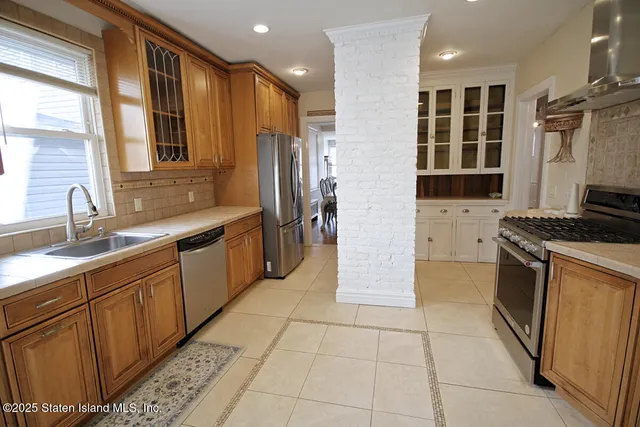 a kitchen with stainless steel appliances a sink stove and refrigerator