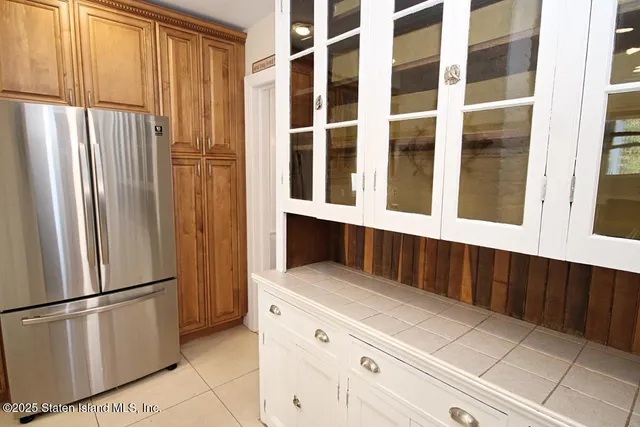 a kitchen with stainless steel appliances a refrigerator and a cabinets