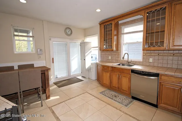 a kitchen with a sink and chairs