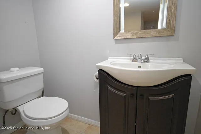 a bathroom with a sink toilet and mirror
