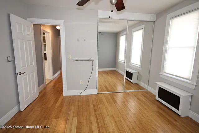 a view of a livingroom with wooden floor and staircase