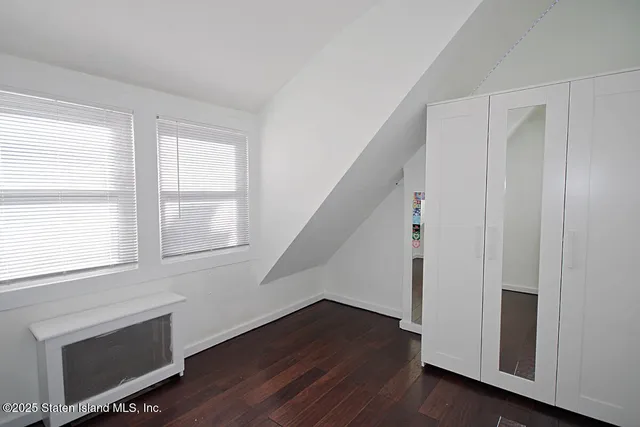 a view of an entryway with wooden floor and staircase