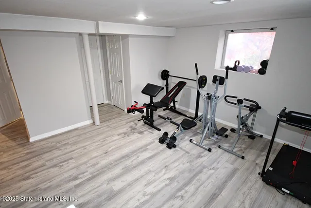 a view of a hallway view with hardwood floor and staircase