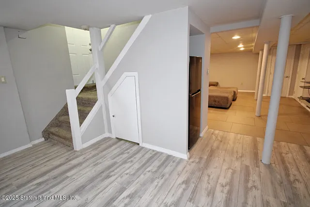 a living room with couches and kitchen view