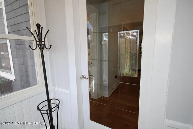 a view of a hallway with furniture and entryway