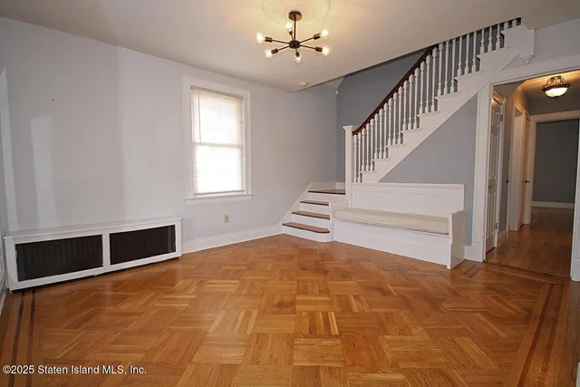 a view of an empty room with stairs