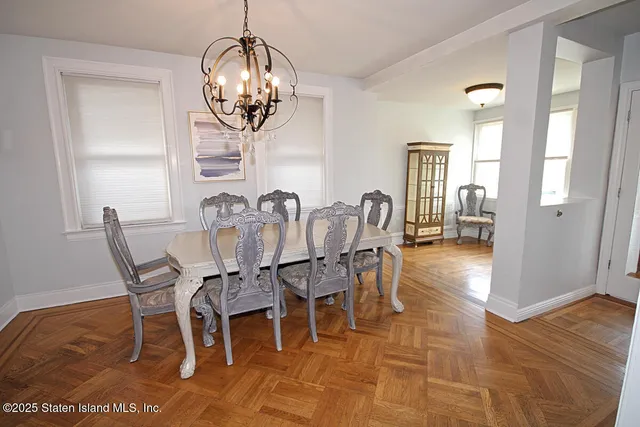a view of a dining room with furniture wooden floor and a chandelier