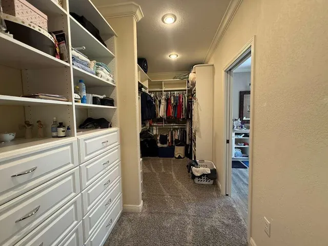 a bathroom with a double vanity sink a mirror and a bathtub