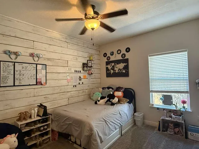 a view of a bedroom with bed and closet