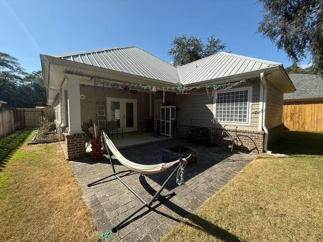 a front view of a house with patio and yard