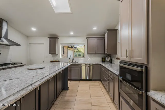 a bathroom with a granite countertop sink mirror vanity and toilet