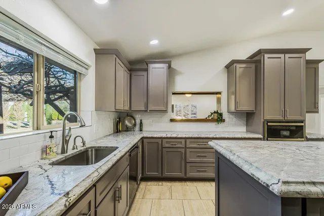 an empty room with closet and windows