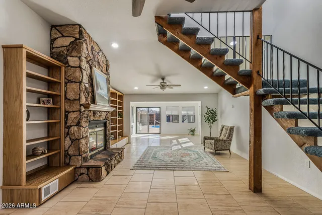 a view of a room with a ceiling fan and a ceiling fan
