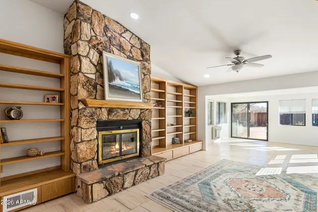 a view of a room with a ceiling fan and a window
