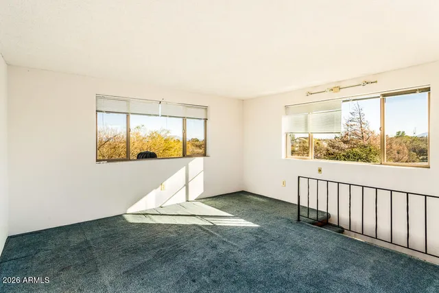 a bedroom with a bed and a ceiling fan
