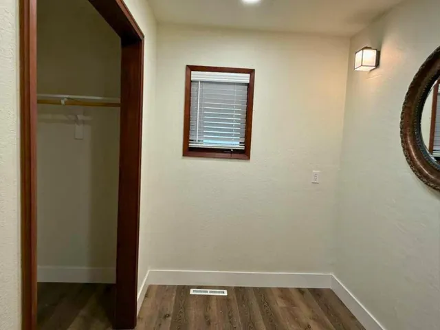 a view of walk in closet with wooden floor
