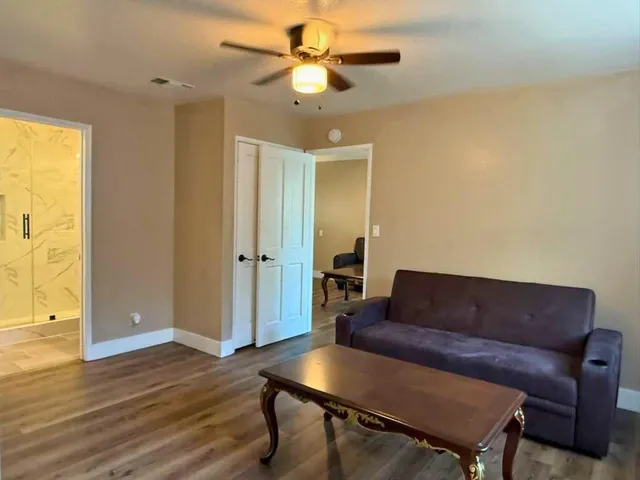 a living room with furniture and a wooden floor