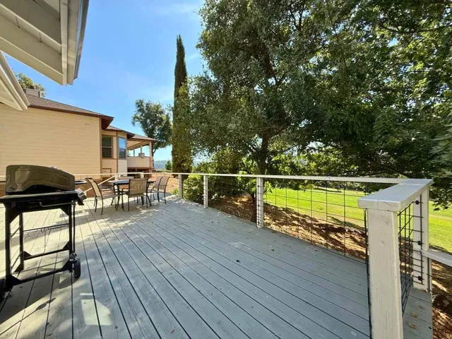 a view of a balcony with chairs and wooden floor